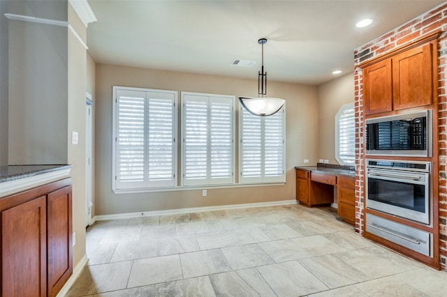 kitchen featuring built in desk, hanging light fixtures, stainless steel oven, stone counters, and built in microwave