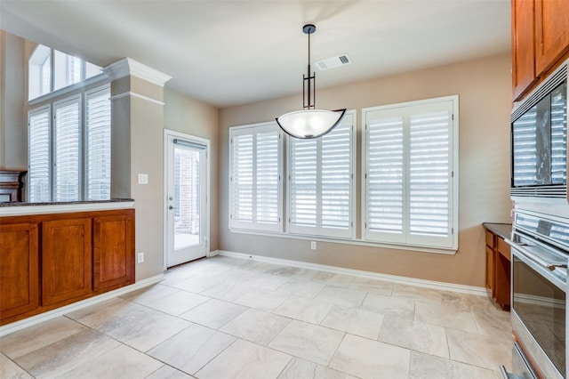 kitchen with pendant lighting, stainless steel oven, and built in microwave