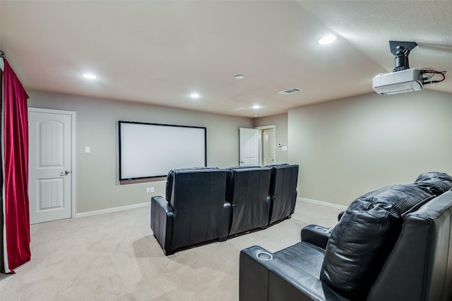 cinema room featuring light carpet