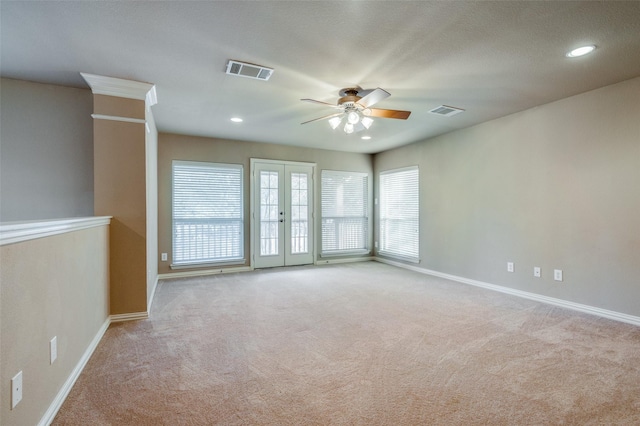 carpeted empty room with ceiling fan and french doors