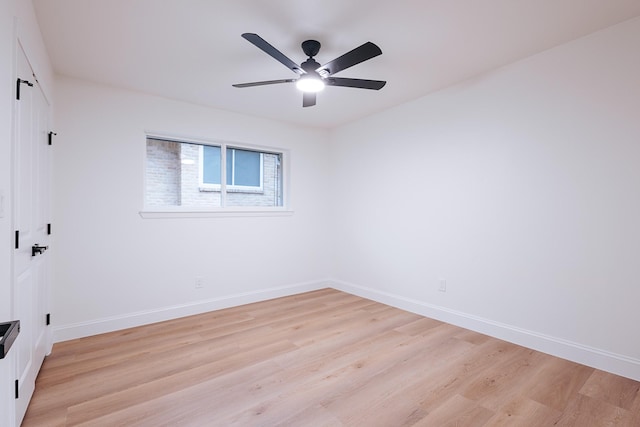 empty room with ceiling fan and light hardwood / wood-style floors