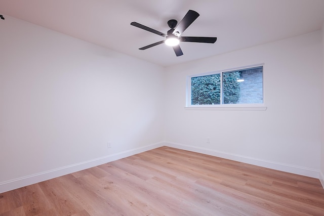 spare room featuring light wood-type flooring and ceiling fan