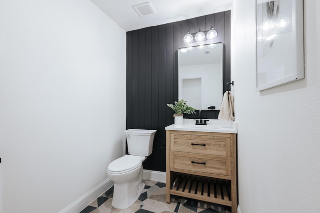 bathroom featuring toilet and vanity