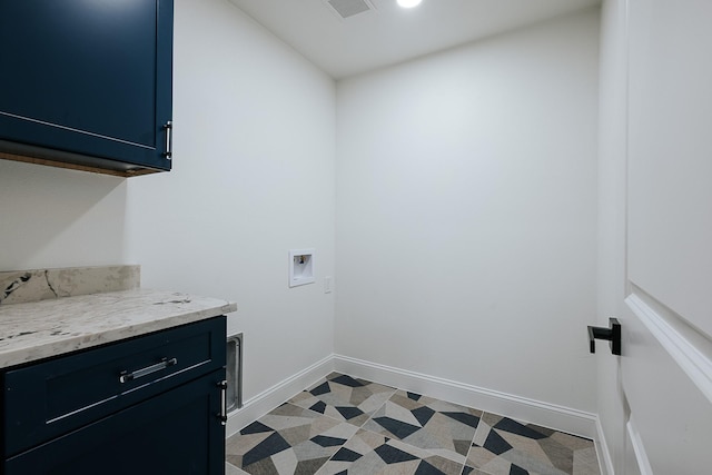 clothes washing area featuring washer hookup and cabinets