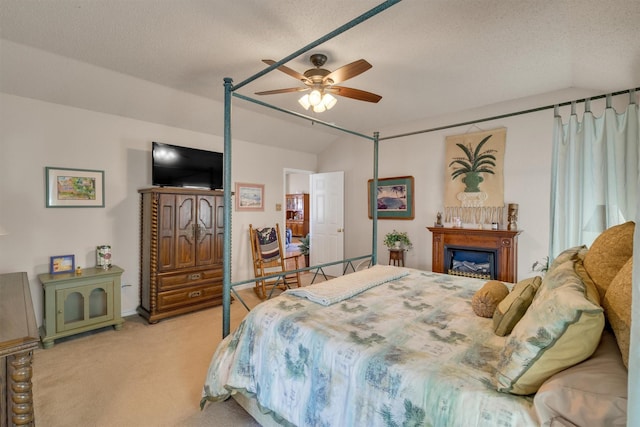 bedroom with ceiling fan, lofted ceiling, a textured ceiling, and light carpet