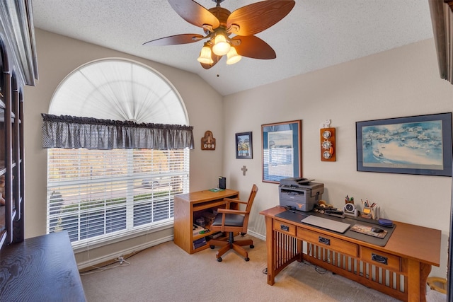 office space featuring a textured ceiling, ceiling fan, carpet floors, and vaulted ceiling