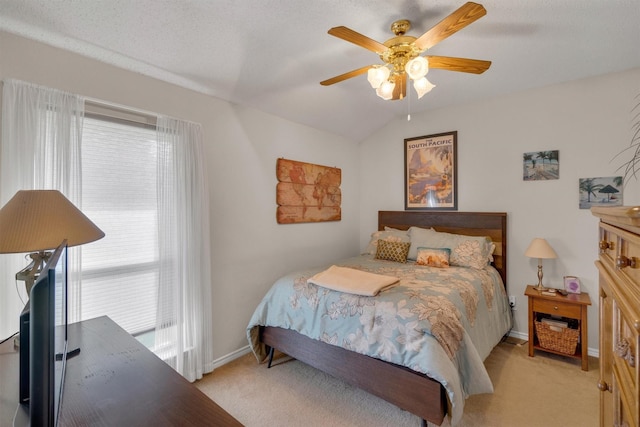 carpeted bedroom featuring multiple windows, a textured ceiling, vaulted ceiling, and ceiling fan