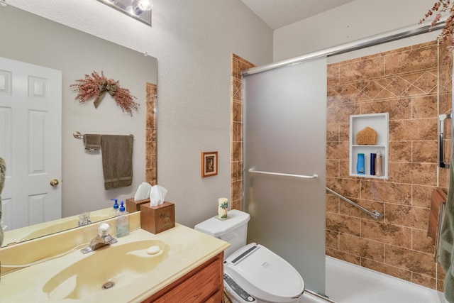 bathroom with vanity, an enclosed shower, and toilet