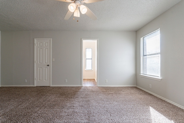 spare room with ceiling fan, carpet, and a textured ceiling