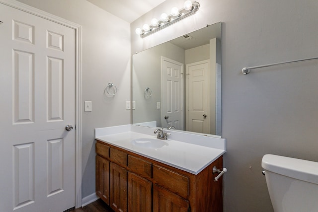 bathroom featuring vanity and toilet