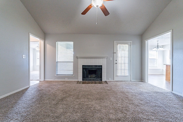 unfurnished living room with carpet, a healthy amount of sunlight, and lofted ceiling