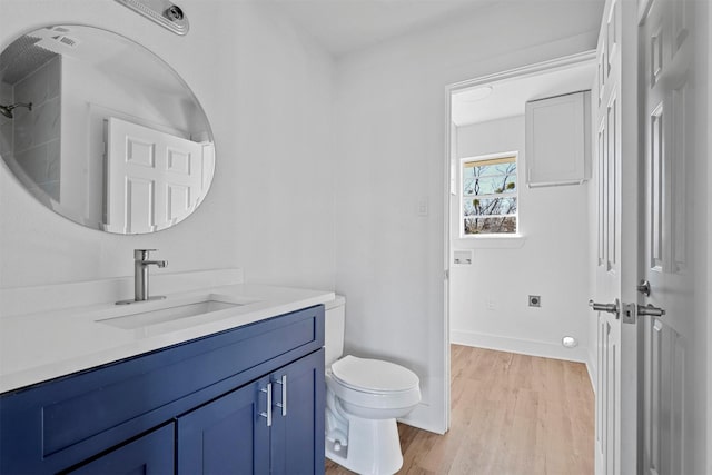 bathroom with vanity, toilet, and wood-type flooring