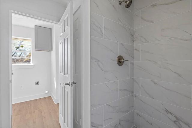 bathroom featuring tiled shower and hardwood / wood-style flooring