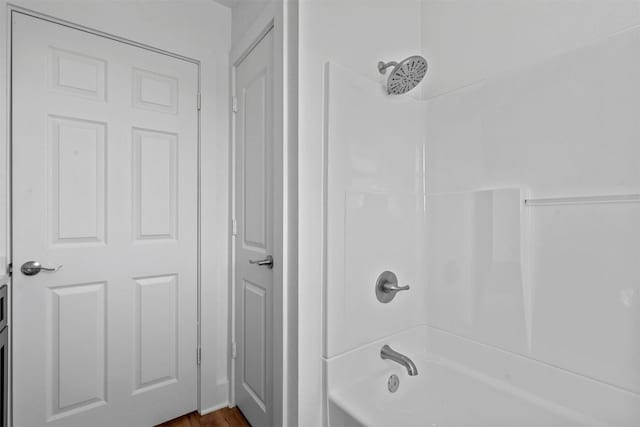 bathroom featuring shower / tub combination and hardwood / wood-style floors