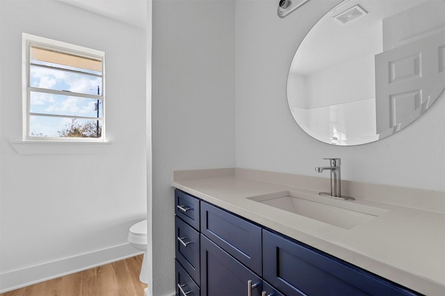 bathroom featuring hardwood / wood-style floors, vanity, and toilet