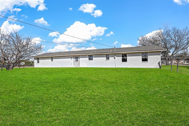 rear view of house with a lawn