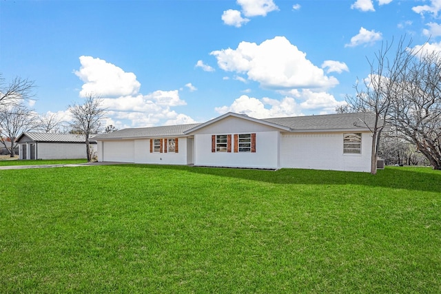 ranch-style house with a garage and a front lawn