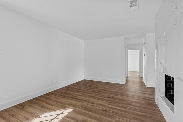 unfurnished living room with a fireplace and dark hardwood / wood-style flooring