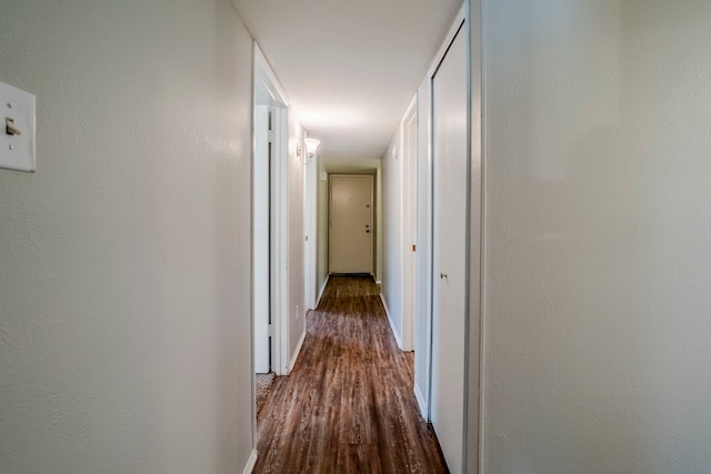 hallway with hardwood / wood-style floors