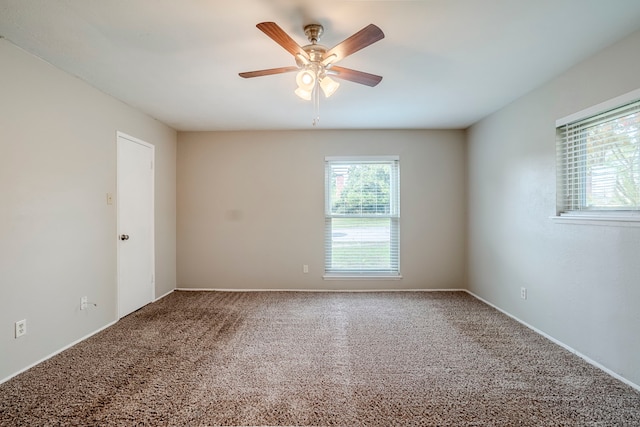 carpeted spare room with ceiling fan