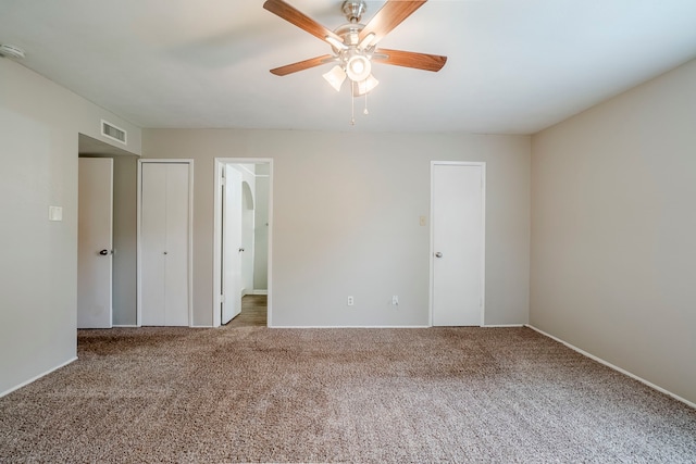 unfurnished bedroom featuring ceiling fan and carpet floors