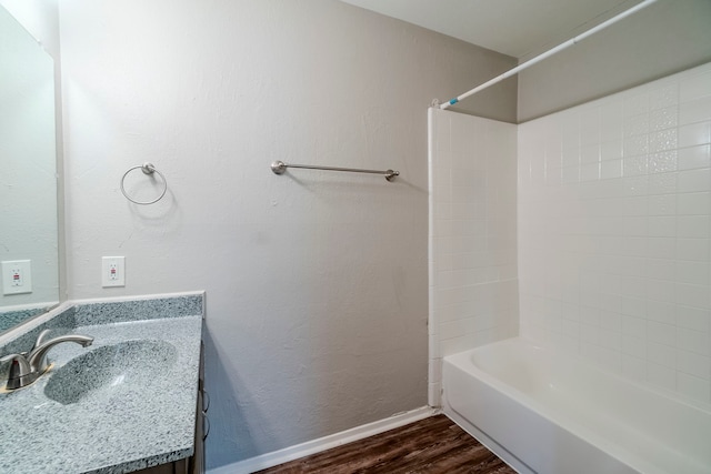 bathroom featuring vanity, hardwood / wood-style flooring, and shower / washtub combination