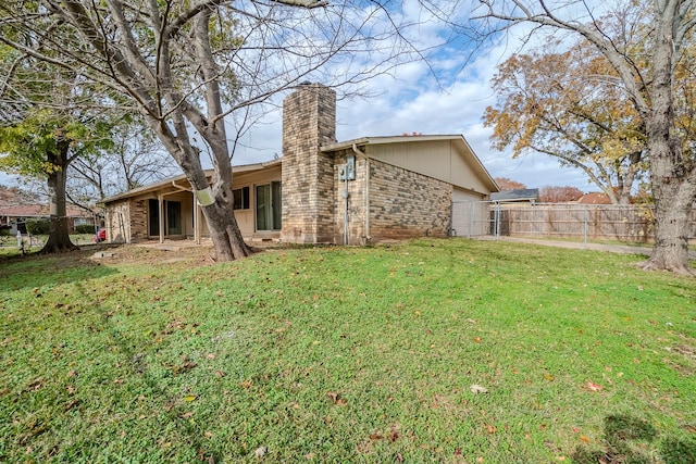 rear view of property featuring a yard