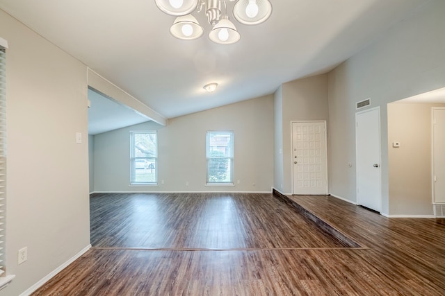 unfurnished room with dark hardwood / wood-style floors, lofted ceiling, and a notable chandelier