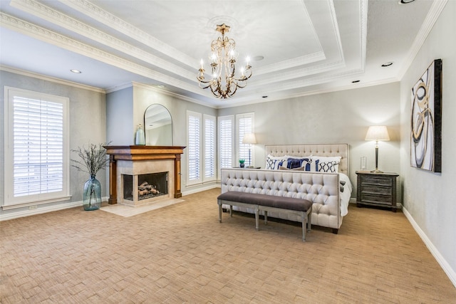 bedroom featuring a tray ceiling, crown molding, multiple windows, and a notable chandelier