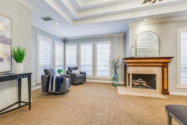 living room featuring a raised ceiling and crown molding