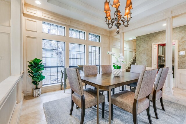 tiled dining area with ornamental molding and a notable chandelier