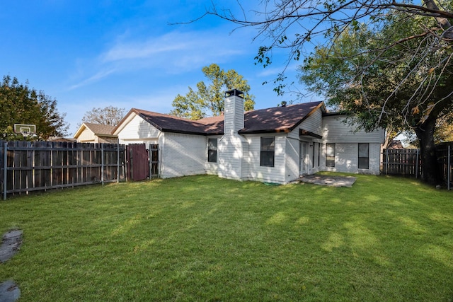 back of house featuring a patio area and a yard