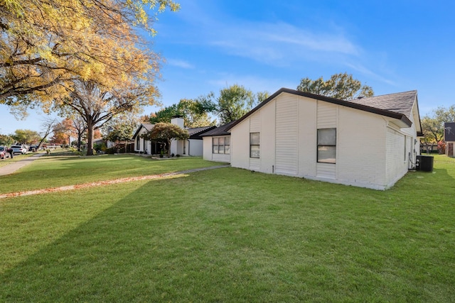 view of home's exterior featuring central AC unit and a lawn