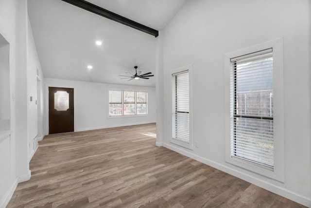 foyer featuring beam ceiling, light wood-type flooring, high vaulted ceiling, and ceiling fan