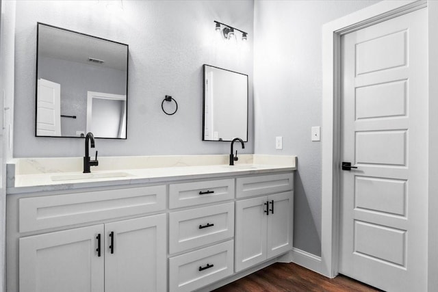 bathroom with hardwood / wood-style floors and vanity