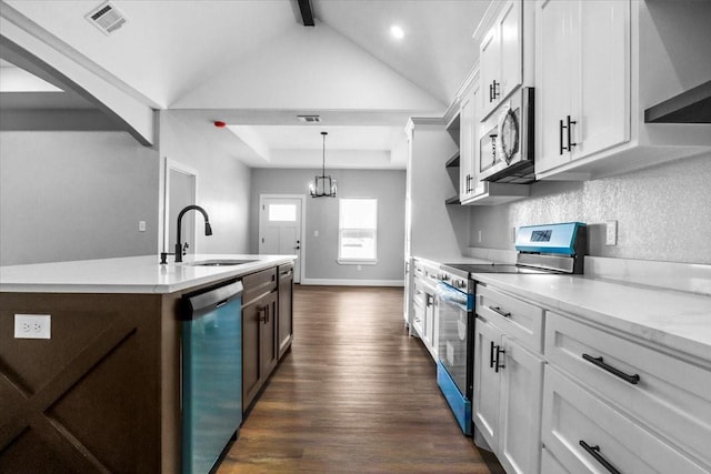 kitchen with white cabinets, decorative light fixtures, sink, and appliances with stainless steel finishes