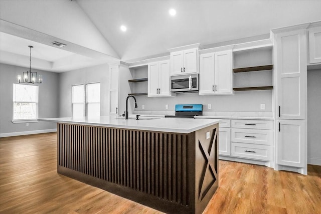 kitchen with white cabinetry, a center island with sink, black range, and pendant lighting