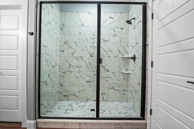 bathroom with hardwood / wood-style floors and walk in shower