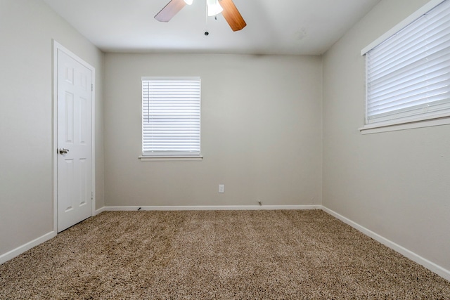 empty room featuring ceiling fan and carpet floors