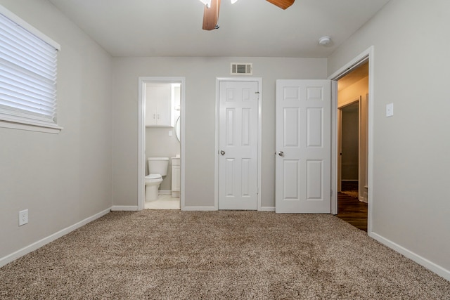 unfurnished bedroom with carpet floors, a closet, ceiling fan, and connected bathroom