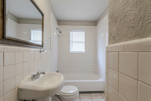 full bathroom featuring sink, tile patterned flooring, decorative backsplash, toilet, and tile walls