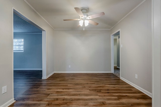 empty room with dark hardwood / wood-style floors, ceiling fan, and crown molding