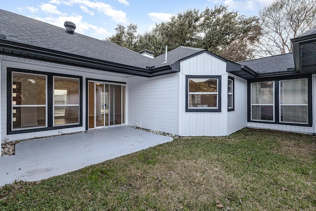 rear view of house with a yard and a patio area