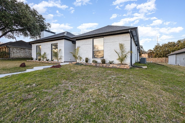 view of front of house featuring central AC and a front yard