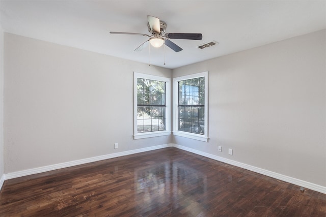 empty room with dark hardwood / wood-style floors and ceiling fan