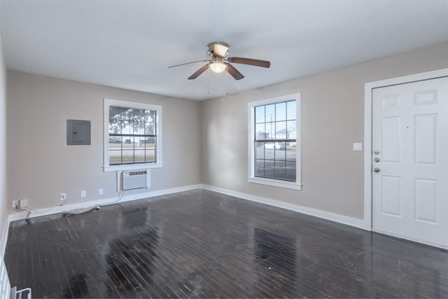 interior space with dark wood-type flooring, a healthy amount of sunlight, electric panel, and a wall mounted AC