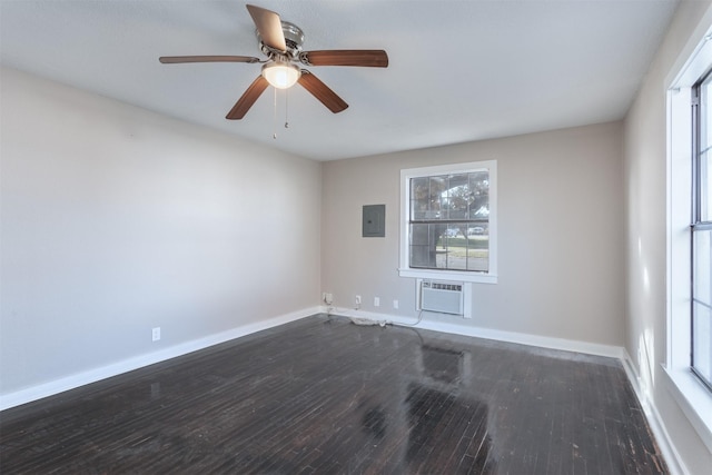 unfurnished room featuring dark wood-type flooring, electric panel, a wall unit AC, and ceiling fan