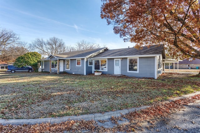 single story home featuring a front yard and a carport