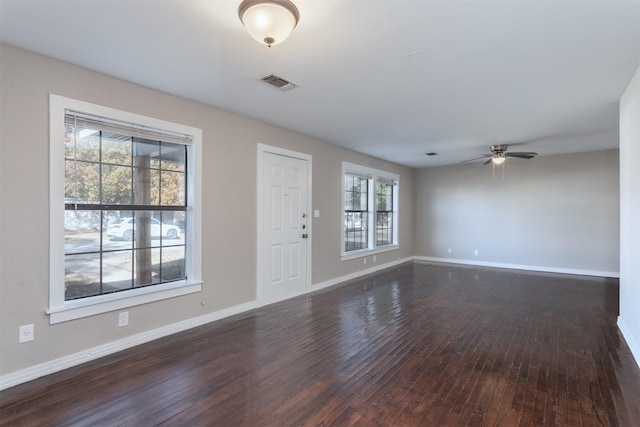 spare room featuring dark hardwood / wood-style floors and ceiling fan