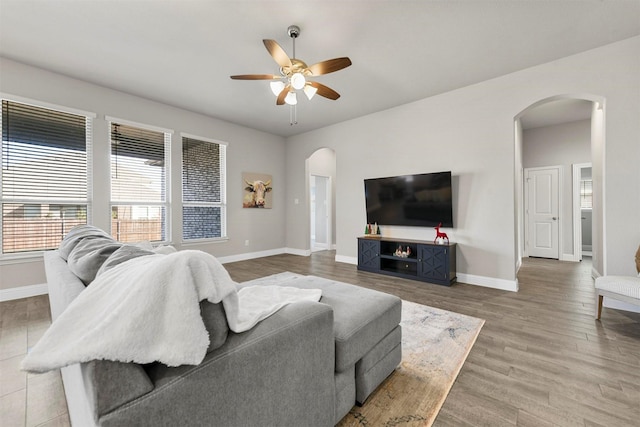 living room featuring ceiling fan and wood-type flooring